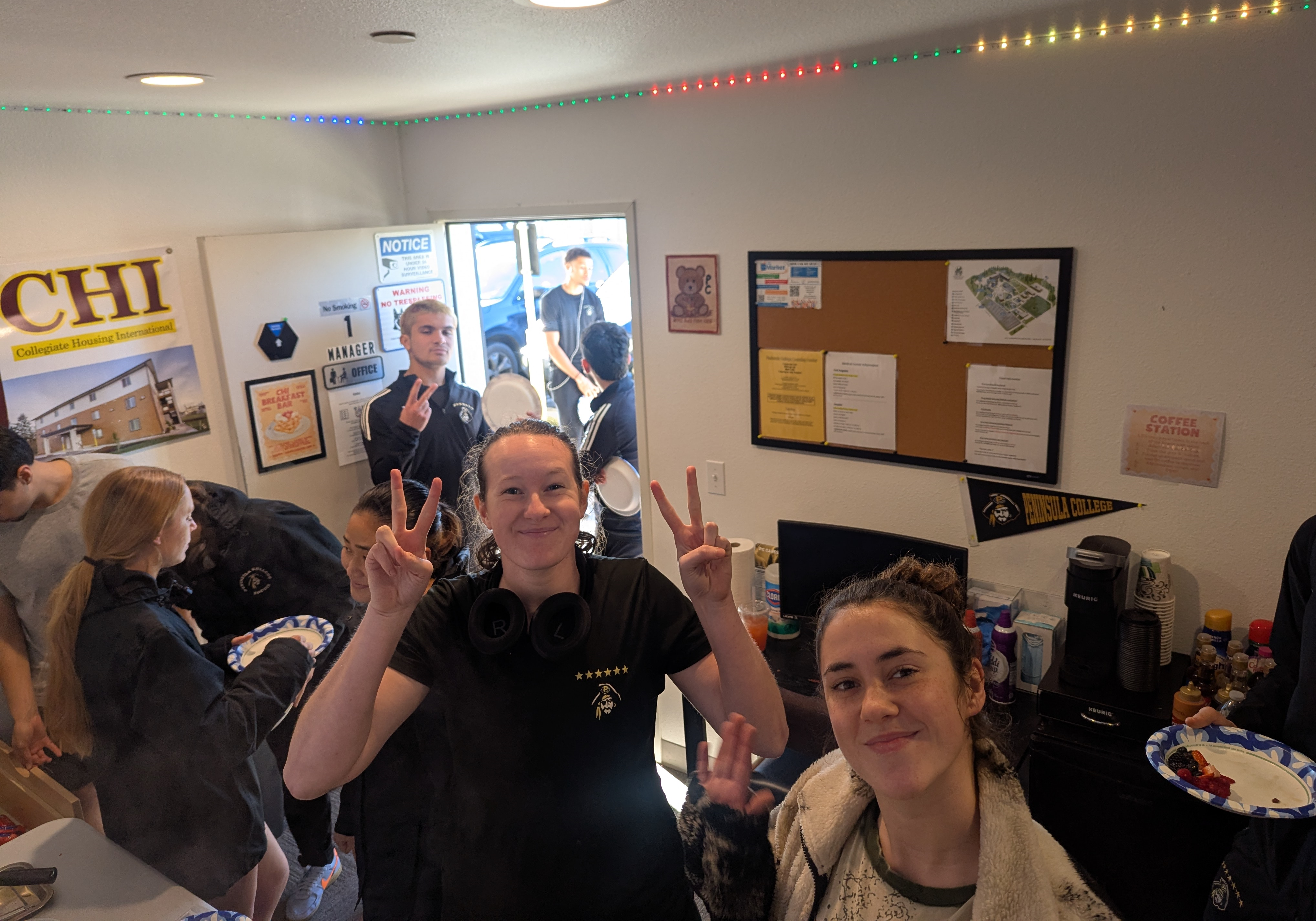 Residents in line to get breakfast flash the peace sign.